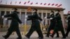 Chinese soldiers march past the Great Hall of the People during a preparatory session of the National People's Congress in Beijing, March 4, 2024.