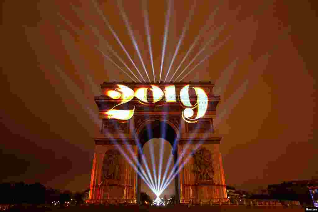 The Arc de Triomphe is lit during New Year's celebration in Paris, France, Jan. 1, 2019.
