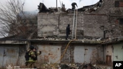 Rescue workers put out a fire in a building that was heavily damaged by a Russian strike on Dnipro, Ukraine, on Nov. 21, 2024. (Ukrainian Emergency Service via AP)