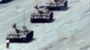FILE - A Beijing citizen stands in front of tanks on the Avenue of Eternal Peace, June 5, 1989.