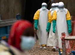 FILE - Health workers begin their shift at an Ebola treatment center in Beni, Democratic Republic of Congo, July 16, 2019.