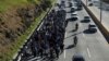 FILE - Salvadorans take part in a new caravan of migrants, heading to the United States, as they leave San Salvador, El Salvador, Jan. 16, 2019. 