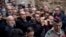 Christian worshippers hold a cross as they walk along the Via Dolorosa towards the Church of the Holy Sepulchre, traditionally believed by many to be the site of the crucifixion of Jesus Christ, during the Good Friday procession in Jerusalem's Old City.