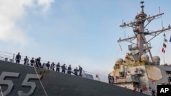 FILE - In this photo provided by the U.S. Navy, sailors aboard the guided missile destroyer USS Stout handle mooring lines during the ship's return to home port at Naval Station Norfolk, Va., Oct. 12, 2020. (Spc. Jason Pastrick/U.S. Navy via AP)