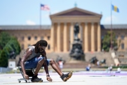 Philadelphia mural artist Felix St. Fort lays out a grid for his creation to be painted on the ground at Eakins Oval in Philadelphia, June 28, 2021. The work titled "Welcome Back, Philly" was expected to be completed ahead of July 4 celebrations.