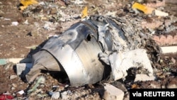 FILE - Debris of a plane belonging to Ukraine International Airlines that crashed after taking off from Iran's Imam Khomeini airport, is seen on the outskirts of Tehran, Iran, Jan. 8, 2020. 