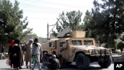 Taliban fighters guard outside the airport in Kabul, Afghanistan, Aug. 27, 2021, a day after a deadly attack.