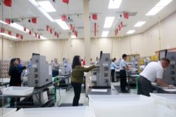 Workers counts ballots at the Broward County Supervisor Of Elections Office during the Florida Primary elections at the Broward County Supervisor Of Elections Office in Lauderhill, Fla., March 17, 2020.