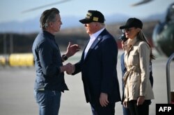 U.S. President Donald Trump, middle, followed by first lady Melania Trump, right, shakes hands with California Governor Gavin Newsom, left, upon arrival at Los Angeles International Airport in Los Angeles, Jan. 24, 2025, to look at how fire devastated much of the region.