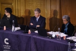 Members of the panel, from left, Ambreena Manji, Nick Vetch and Parveen Kumar listen as Chair of the panel Geoffrey Nice gives the opening address on the first day of hearings at the "Uyghur Tribunal" On June 4, 2021.