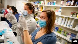 Medicinske sestre i farmaceuti pripremaju vakcine protiv virusa Kovid 19. Denver, Kolorado, 6. mart 2021. (Foto: AP/David Zalubowski)