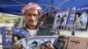 FILE - A man reads a copy of Israel-Kurd magazine in Irbil, Iraq, Aug. 16, 2009.