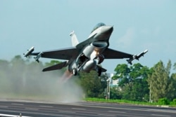 FILE - A Taiwanese Air Force F-16 fighter jet takes off from a closed section of highway during the annual Han Kuang military exercises in Chiayi, central Taiwan, Sept. 16, 2014.