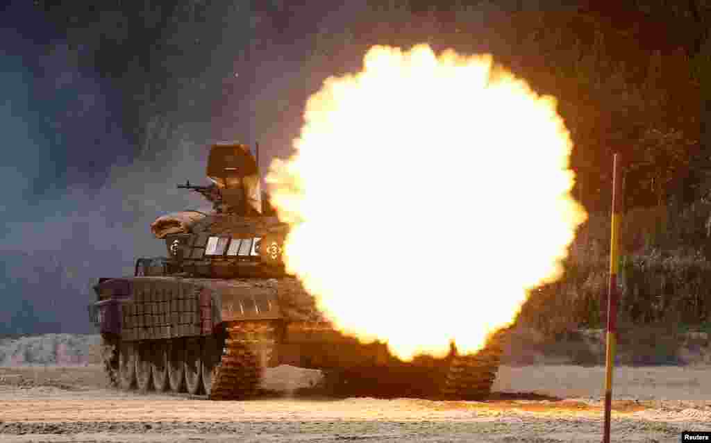 A T-72B1 tank fires during the Safe Route competition at the International Army Games 2017 at the Andreyevsky military polygon outside Tyumen, Russia.