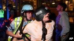 A demonstrator is taken into custody by police police near the Israeli Consulate during the Democratic National Convention Aug. 20, 2024, in Chicago.