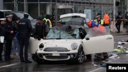 Police work at a car which drove into a crowd in Munich, Germany, Feb. 13, 2025, injuring several people.