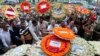FILE - Local residents pay their respects to the victims of the attack at the Holey Artisan Bakery at a stadium in Dhaka, Bangladesh, July 4, 2016. 