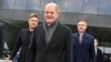 German Chancellor-designate Olaf Scholz, center, and represenatives of ruling coalition parties leave the Futurium venue after a signing ceremony in Berlin, Dec. 7, 2021. 