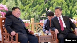 FILE - North Korean leader Kim Jong Un meets with China's President Xi Jinping, in Dalian, China, in this undated photo released on May 9, 2018, by North Korea's Korean Central News Agency.
