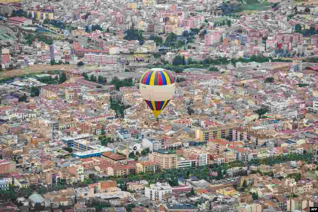 A hot-air balloon flies over Igualada, near Barcelona, Spain, during the 21st European Balloon Festival.