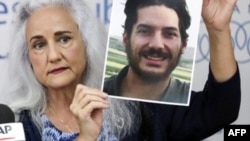 FILE - Debra Tice, mother of U.S. journalist Austin Tice, holds a portrait of her son during a press conference in Beirut, Lebanon, July 20, 2017. Tice has been held in Syria since 2012. On Dec. 24, 2024, Hostage Aid Worldwide said it believes Tice is still alive. 