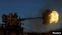 Ukrainian members of the military fire an anti-aircraft weapon, as Russia's attack on Ukraine continues, in the frontline city of Bakhmut, Ukraine, Jan. 10, 2023. 