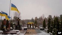 Honor guards carry the coffin of fallen Ukrainian serviceman Serhii Solovyov, who was killed during fighting with Russian forces in Kursk on Nov. 12, during the funeral ceremony in Irpin, Ukraine, on Nov. 21, 2024.
