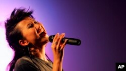 FILE - Hong Kong singer Coco Lee performs during a mini concert as celebrating an opening ceremony of a new hotel in Hong Kong, Aug. 19, 2005. Coco Lee, a Hong Kong-born singer who had a highly successful career in Asia, died July 5, 2023.