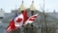 A Canadian flag flutters between a U.S. flag and a Washington, D.C., flag in front of the White House in Washington, March 7, 2016. Preparations are under way for the official state visit of Canada's Prime Minister Justin Trudeau on Thursday. 
