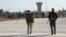 Members of the Kurdish-led Syrian Democratic Forces walk at Qamishli international airport in Qamishli, Syria, Dec. 9, 2024. 
