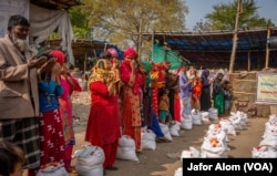 Rohingya refugees collect food from a community charitable organization in Faridabad, Haryana, India, in early 2024.