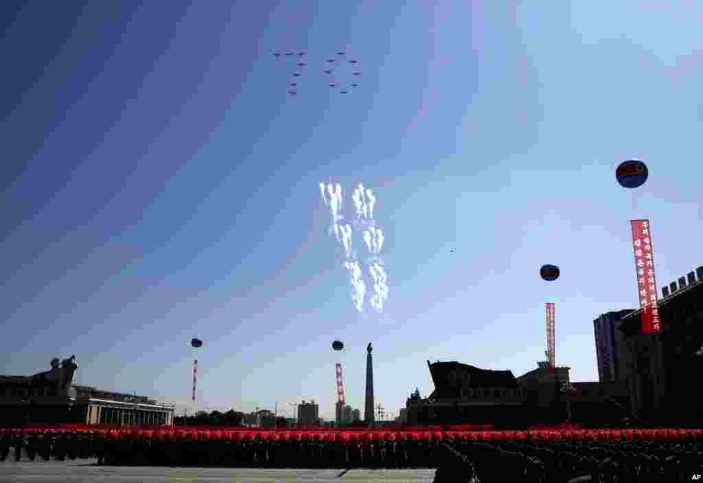 Airplanes forming the number 70 fly in formation and fire flares during a parade for the 70th anniversary of North Korea's founding day in Pyongyang, North Korea, Sept. 9, 2018.