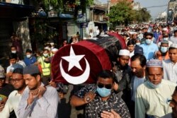 People attend the funeral of a woman who was shot dead Feb. 28, 2021, while police were trying to disperse an anti-coup demonstration in Mandalay, Myanmar, March 1, 2021.
