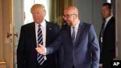 U.S. President Donald Trump speaks with Belgian Prime Minister Charles Michel prior to a meeting at the Royal Palace in Brussels, May 24, 2017. 