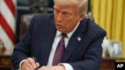 FILE - U.S. President Donald Trump signs an executive order on birthright citizenship in the Oval Office of the White House in Washington on Jan. 20, 2025.