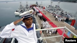 FILE - A Cambodian navy sailor salutes on a Chinese naval patrol boat during a handover ceremony at a Cambodian naval base at Ream in Sihanoukville province, southwest of Phnom Penh, on November 7, 2007. REUTERS/Chor Sokunthea