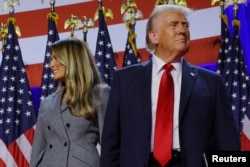 Republican presidential nominee former U.S. President Donald Trump is joined onstage by his wife Melania at his election night rally at the Palm Beach County Convention Center in West Palm Beach, Florida, Nov. 6, 2024.