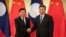 FILE - Laos' Prime Minister Thongloun Sisoulith and China's President Xi Jinping shake hands before a meeting at the Great Hall of the People in Beijing, China, Jan. 6, 2020.