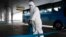 FILE - A State Commission of Quality Management staff member in protective gear disinfects a ground transportation area at the Pyongyang Airport in Pyongyang, North Korea, Feb. 1, 2020. 