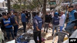 팔레스타인들과 현지 언론인들이 31일 이스라엘의 폭격을 받은 가자 지구 중부 지역 내 알 아크사 순교자 병원 앞 임시 캠프에서 피해 상황을 점검하고 있다.