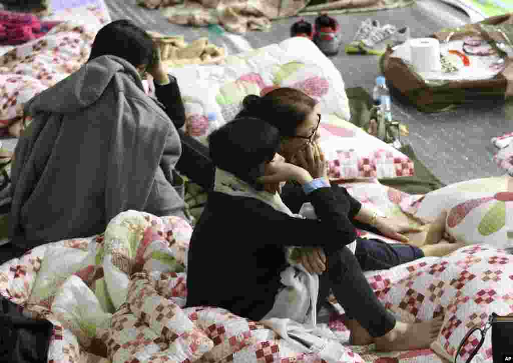 Mothers of the missing children that were aboard the sunken ferry listen to South Korean President Park Geun-hye speak, Jindo, South Korea, April 17, 2014.