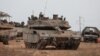 Sebuah tank dan kendaraan militer Israel terlihat di dekat perbatasan Israel dengan Jalur Gaza, di Israel selatan, 22 Oktober 2023. (Foto: REUTERS/Violeta Santos Moura)