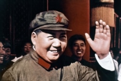 FILE - Chinese Communist Party leader Mao Zedong smiles and waves in 1969.