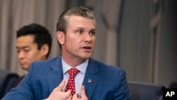 Secretary of Defense Pete Hegseth responds to a reporter's question at the Pentagon, Feb. 7, 2025, near Washington.