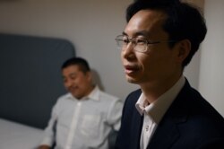 Lawyers Zhang Keke (R) and Ren Quanniu, representing Chinese citizen journalist Zhang Zhan, in Shanghai, China on December 27, 2020.