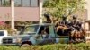 Des troupes circulent dans un véhicule près de l'ambassade de France dans le centre de Ouagadougou, au Burkina Faso, le vendredi 2 mars 2018. (AP Photo / Ludivine Laniepce)