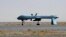 FILE - U.S. Predator unmanned drone armed with a missile stands on the tarmac of Kandahar military airport in Afghanistan. 