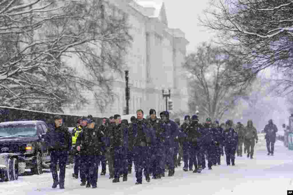 Police from nearby Arlington, Virginia, arrive at the Capitol to help reinforce the security presence ahead of a joint session of Congress to certify the votes from the Electoral College in the presidential election, in Washington, Jan. 6, 2025.