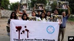 Members of the social group "Umeed Jawan Peace Society" hold pictures of prominent women's rights activist Sabeen Mahmud, who was killed by unknown gunmen, during a demonstration to condemn her killing, Saturday, April 25, 2015, in Lahore, Pakistan.