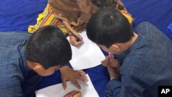 This September 2021 photo provided by their mother shows three children in Afghanistan. Every night, their father, a US green card holder from California, and his wife take turns sleeping, with one always awake so they can flee the Taliban.